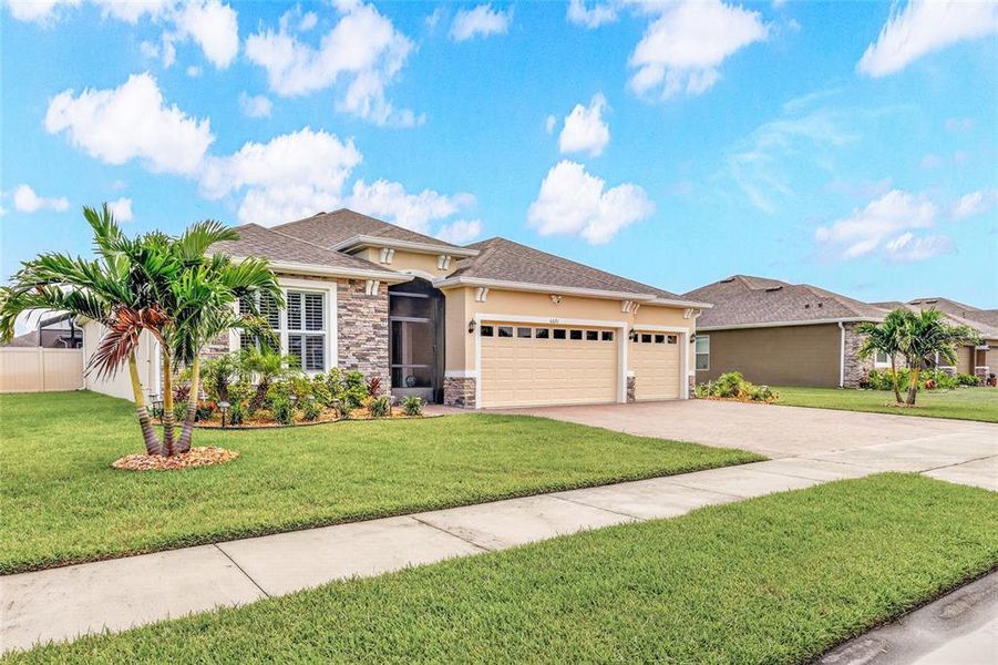 Front exterior of a new home in Crystal Bay Estates, Grant-Valkaria, FL, highlighting curb appeal (Image 1). Front exterior of a new home in Crystal Bay Estates, Grant-Valkaria, FL, highlighting curb appeal (Image 1).