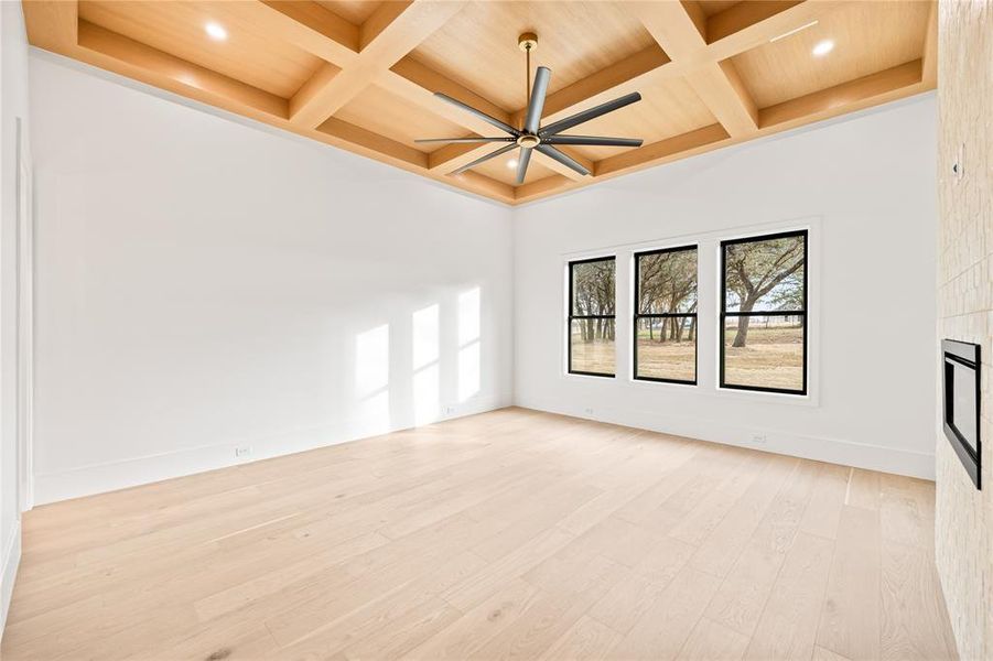 Unfurnished room featuring light wood-style floors, coffered ceiling, beamed ceiling, ceiling fan, and recessed lighting