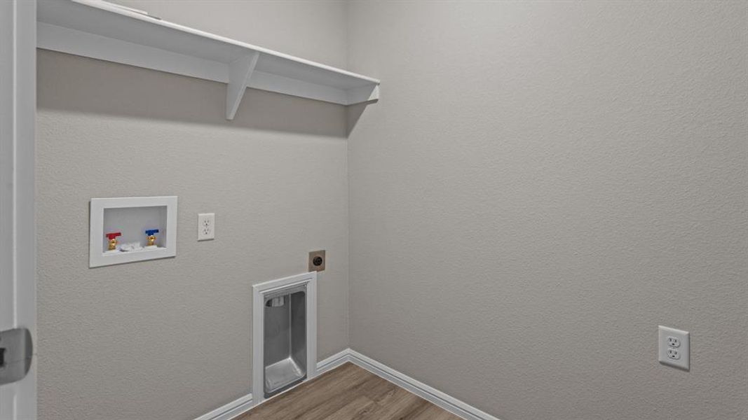 Laundry room featuring washer hookup, electric dryer hookup, dark wood-type flooring, and baseboards Laundry room featuring washer hookup, electric dryer hookup, dark wood-type flooring, and baseboards