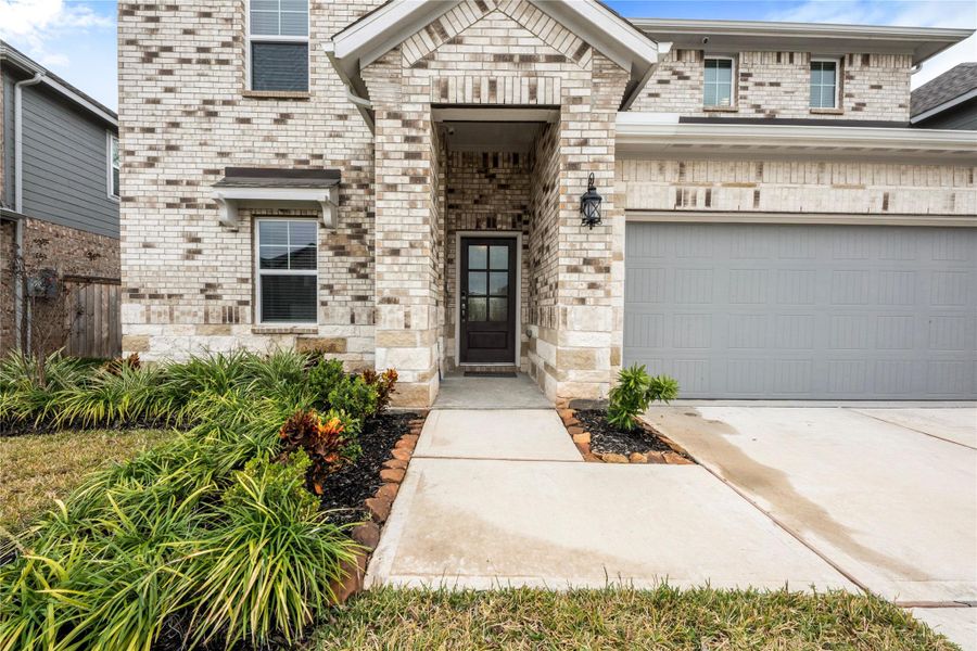 Charming front exterior with an inviting curb appeal, featuring a well-maintained lawn, clean architectural lines, and a welcoming entryway that reflects the quiet, family-friendly atmosphere of Bellfort Farms.