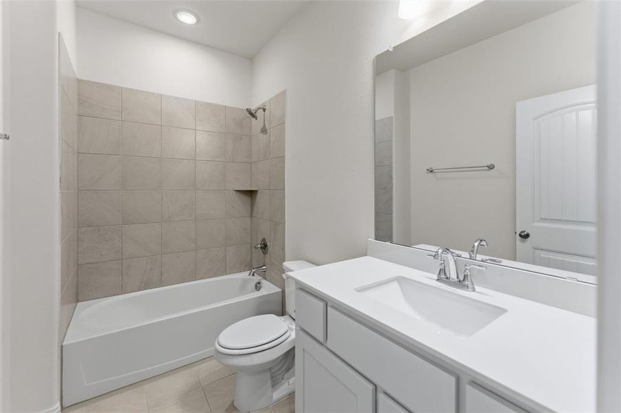 Full bathroom featuring vanity, shower / bath combination, and light tile patterned floors