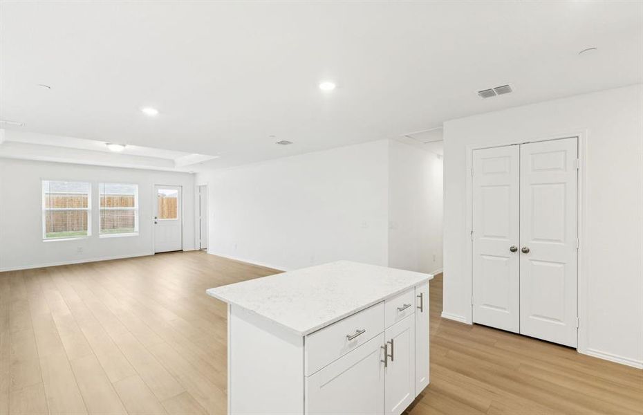 Island overlooking gathering room and dining areas