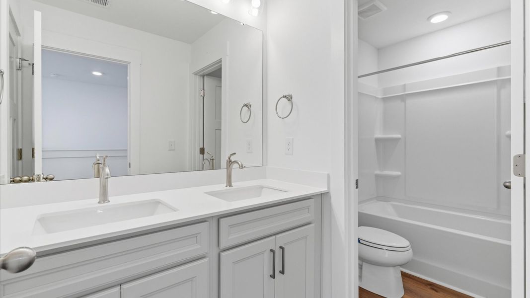 Well-appointed full bath with high standards of craftsmanship and everyday function at this single family home at Foxbank