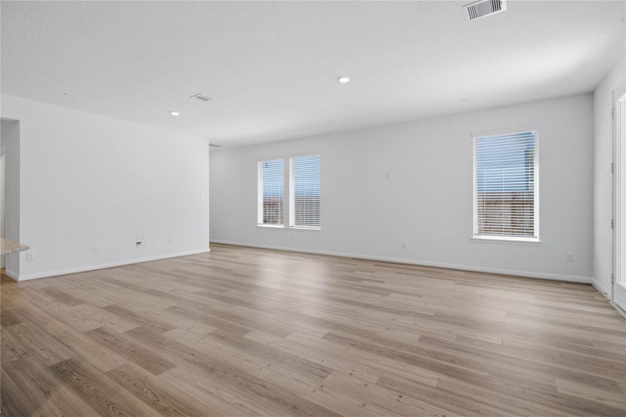 This bright and airy Great Room offers a spacious layout ideal for both relaxing evenings and lively gatherings. Designed for comfort and connection, it features vinyl plank flooring, large windows with blinds, high ceilings, recessed lighting, and seamless access to the stunning kitchen—perfect for everyday living and entertaining alike. This bright and airy Great Room offers a spacious layout ideal for both relaxing evenings and lively gatherings. Designed for comfort and connection, it features vinyl plank flooring, large windows with blinds, high ceilings, recessed lighting, and seamless access to the stunning kitchen—perfect for everyday living and entertaining alike.