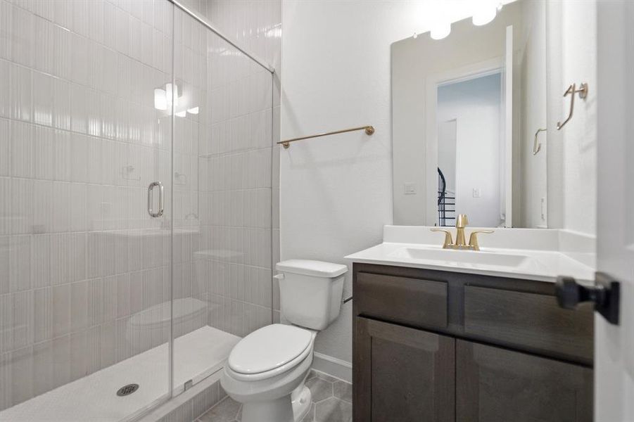 Shower with a clear glass enclosure and vertically stacked white tile, featuring a white shower pan