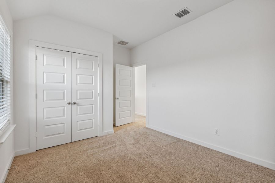 Bedroom in the Oak II home plan by Trophy Signature Homes – REPRESENTATIVE PHOTO