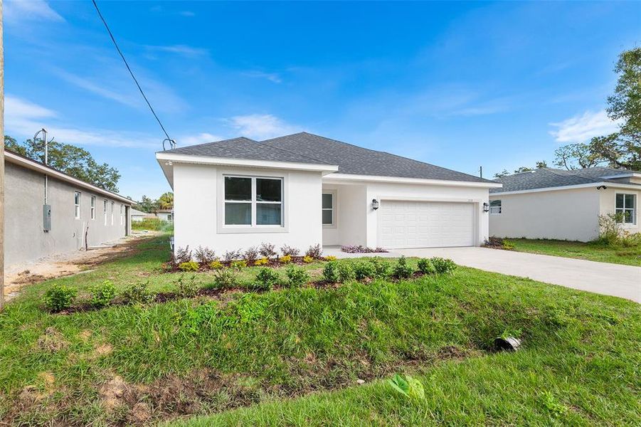 Front exterior of a new home in , Winter Haven, FL, highlighting curb appeal (Image 2). Front exterior of a new home in , Winter Haven, FL, highlighting curb appeal (Image 2).