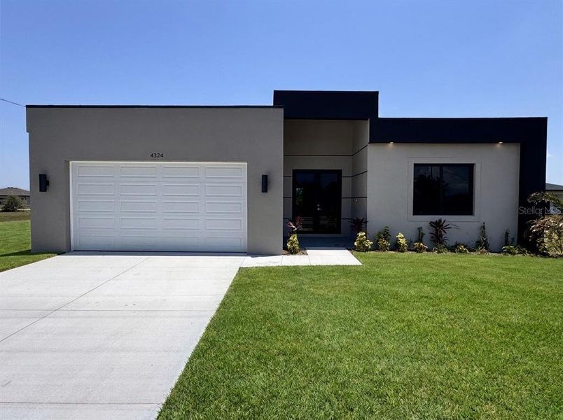 Front exterior of a new home in , Cape Coral, FL, highlighting curb appeal (Image 2). Front exterior of a new home in , Cape Coral, FL, highlighting curb appeal (Image 2).