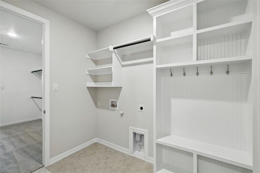 Laundry room with electric dryer hookup, hookup for a gas dryer, hookup for a washing machine, and carpet Laundry room with electric dryer hookup, hookup for a gas dryer, hookup for a washing machine, and carpet