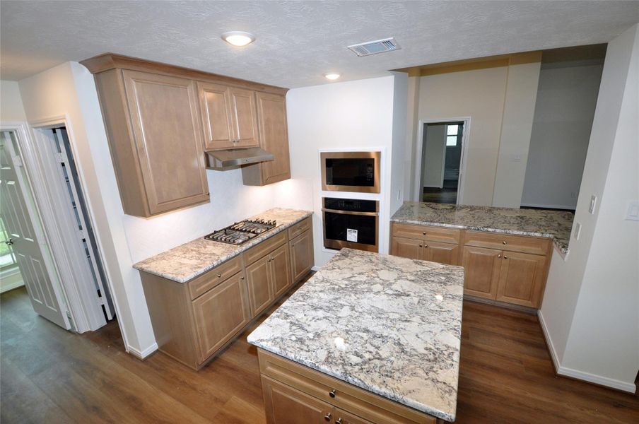 Island Kitchen features limited edition Maple Barley Cabinetry and  under cabinet LED lighting.