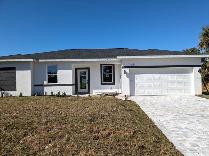 Front exterior of a new home in , Port Charlotte, FL, highlighting curb appeal (Image 18).