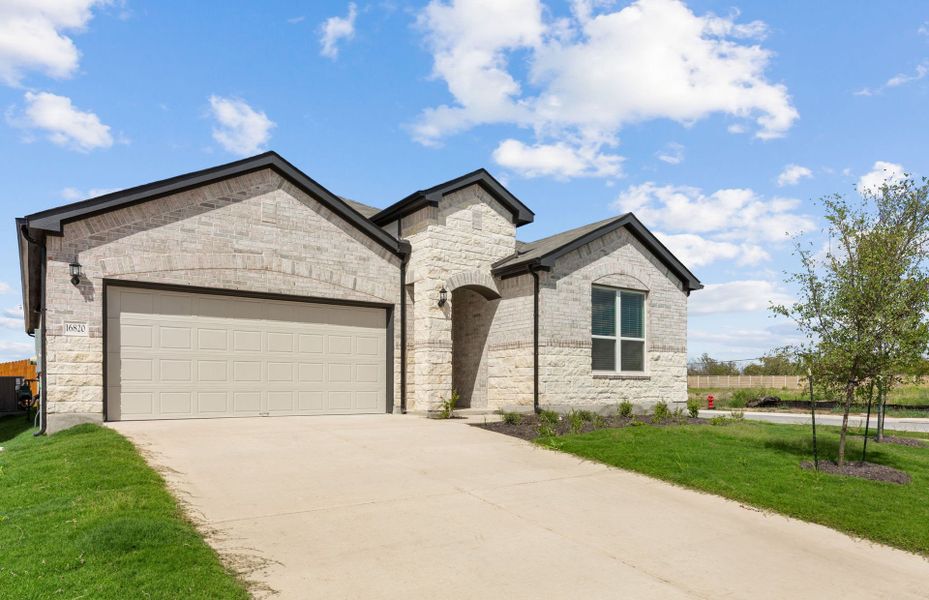 Front exterior of a new home in Lagos, Manor, TX, highlighting curb appeal (Image 20).