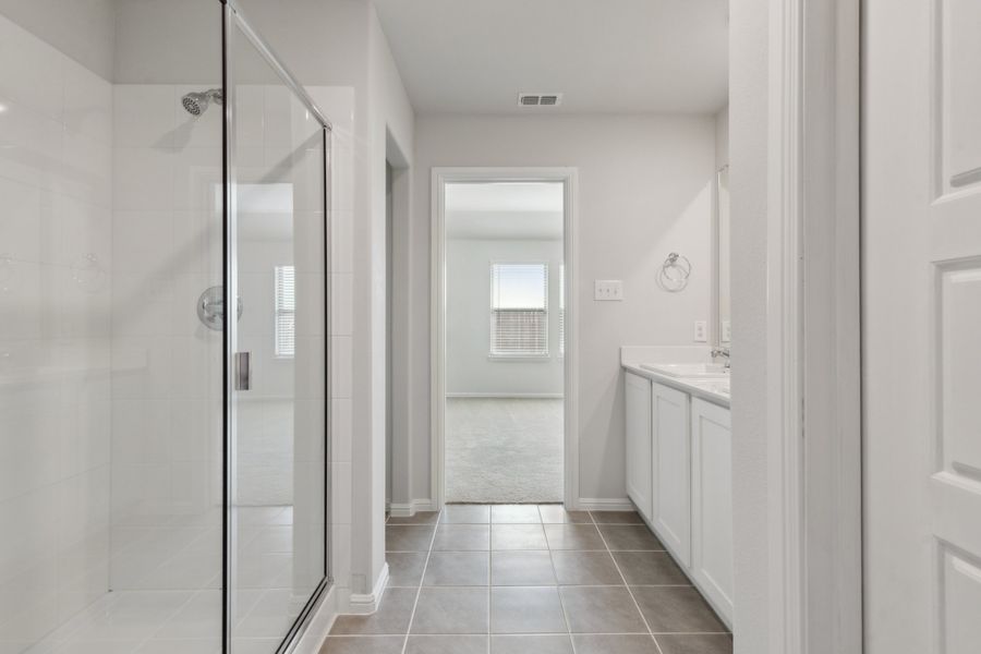 Primary Bathroom in the Hayden home plan by Trophy Signature Homes – REPRESENTATIVE PHOTO