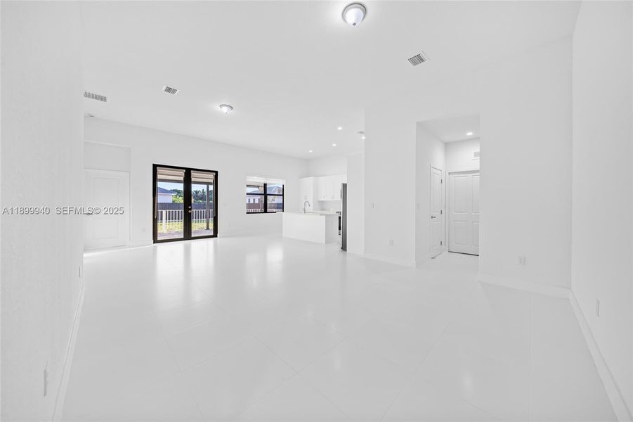 Great Room (view of dining, living, kitchen, door to 1/2 bath and laundry)