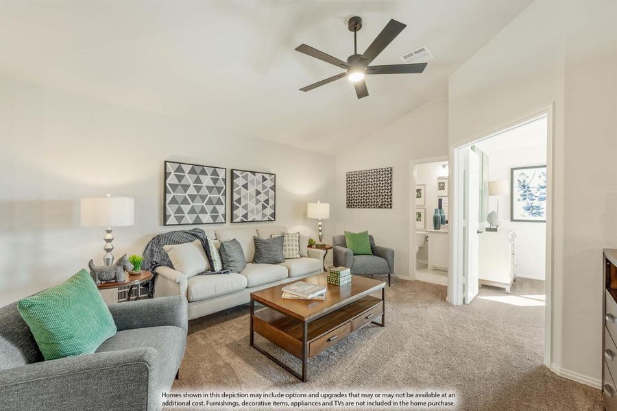 Living room with vaulted ceiling, ceiling fan, gray sofas, wood coffee table, and carpet flooring