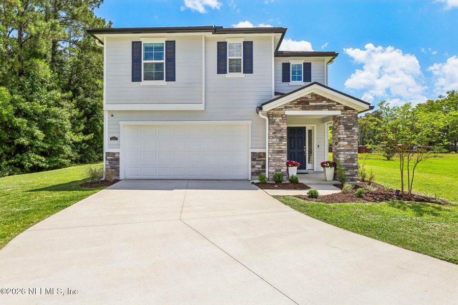 Front exterior of a new home in Dunns Crossing, Jacksonville, FL, highlighting curb appeal (Image 2). Front exterior of a new home in Dunns Crossing, Jacksonville, FL, highlighting curb appeal (Image 2).