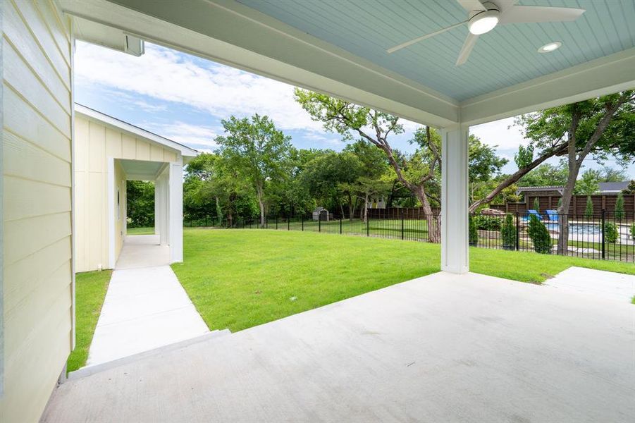 Covered patio with a light blue beadboard ceiling and modern ceiling fan Covered patio with a light blue beadboard ceiling and modern ceiling fan