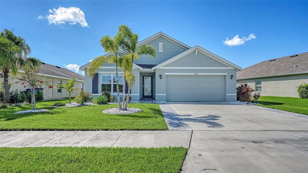 Front exterior of a new home in Bella Lago, Parrish, FL, highlighting curb appeal (Image 26). Front exterior of a new home in Bella Lago, Parrish, FL, highlighting curb appeal (Image 26).