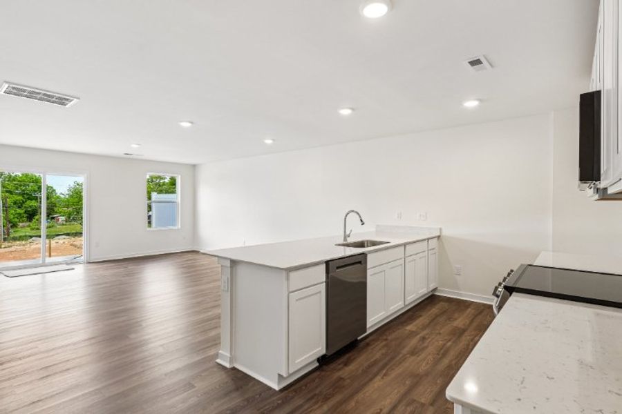 A kitchen with white cabinets.