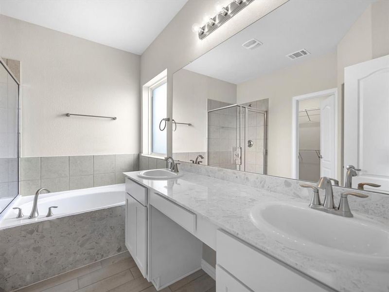 A bathroom with a tub sink and a bathtub. A bathroom with a tub sink and a bathtub.