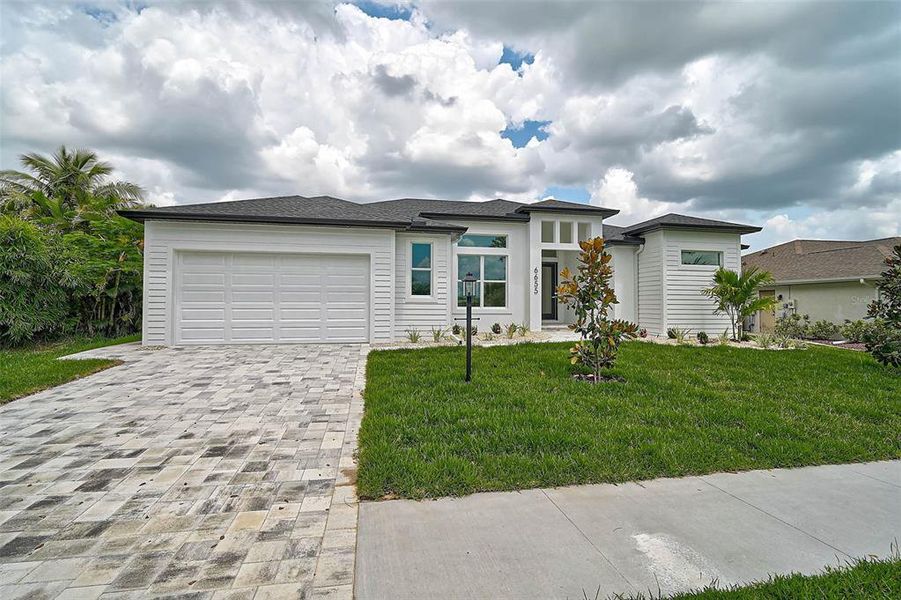Front exterior of a new home in , North Port, FL, highlighting curb appeal (Image 27).