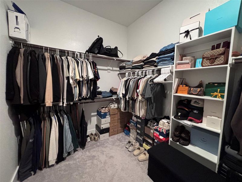 Spacious walk-in closet with ample hanging space, shelving for accessories, and organized shoe storage, perfect for keeping your wardrobe tidy and accessible.