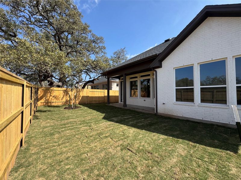 Fenced backyard with a patio