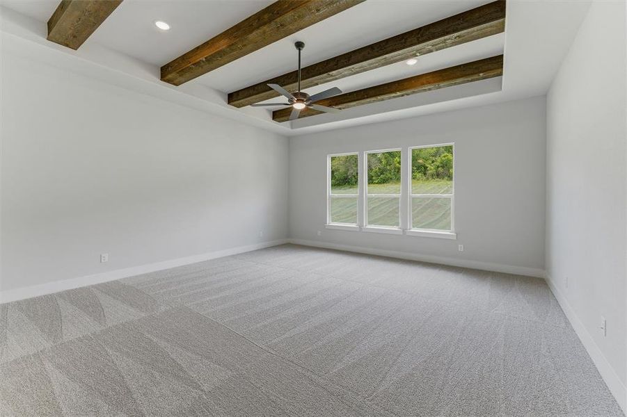 Tray ceiling with exposed wood beams, recessed lighting, and a ceiling fan