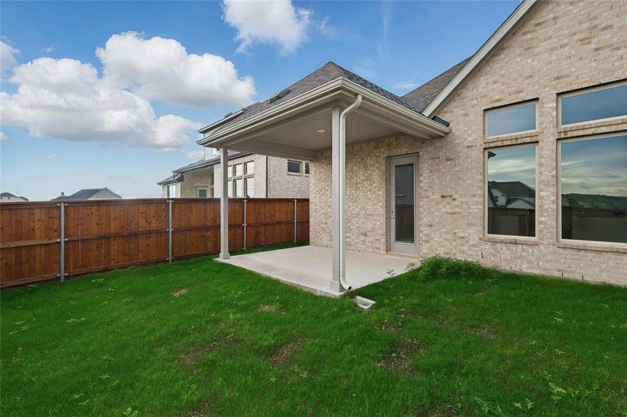Back of property featuring a patio area and brick siding Back of property featuring a patio area and brick siding