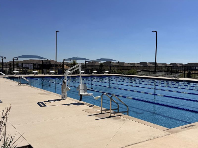 Community pool with a residential view and a patio area Community pool with a residential view and a patio area