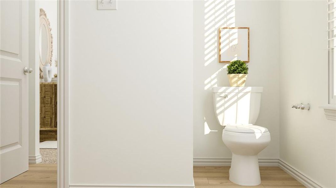 Bathroom with toilet and hardwood / wood-style floors