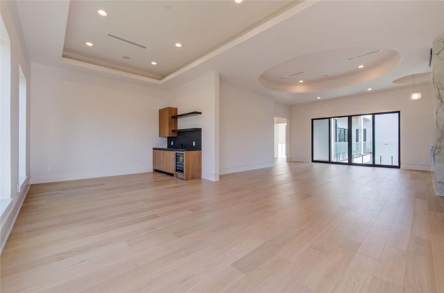 Expansive primary retreat featuring a built-in wet bar/coffee station complete with a beverage fridge for added luxury and convenience. Expansive primary retreat featuring a built-in wet bar/coffee station complete with a beverage fridge for added luxury and convenience.