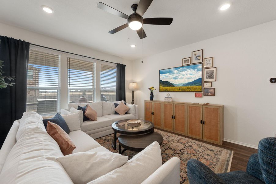 Living area featuring a ceiling fan, wood finished floors, and recessed lighting