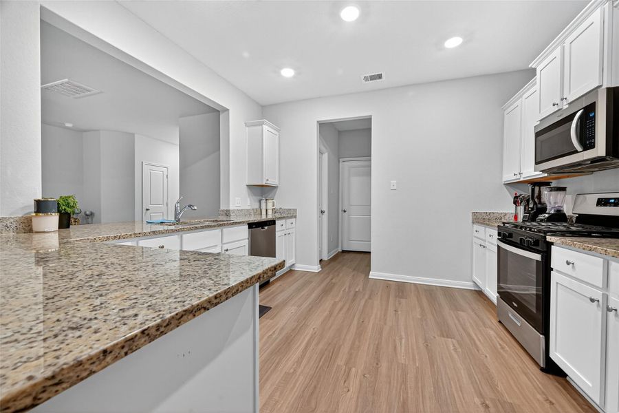 Spacious kitchen with granite counter tops, and updated recessed lighting. Spacious kitchen with granite counter tops, and updated recessed lighting.