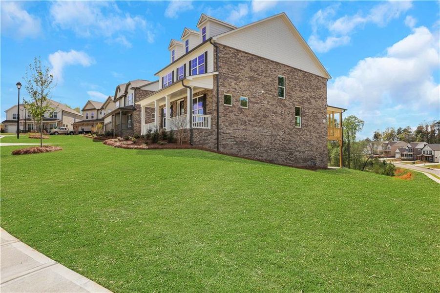 Front exterior of a new home in Cambridge, Flowery Branch, GA, highlighting curb appeal (Image 2). Front exterior of a new home in Cambridge, Flowery Branch, GA, highlighting curb appeal (Image 2).