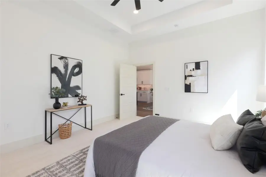 Bedroom with carpet, a raised ceiling, a ceiling fan, and recessed lighting