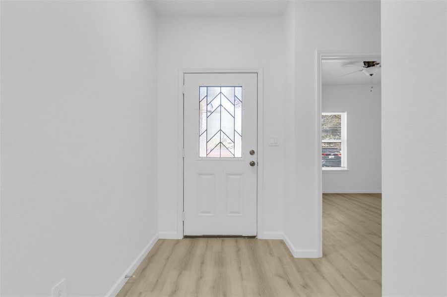 Entryway featuring light wood-type flooring and baseboards