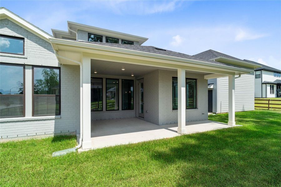 The spacious covered patio offers a tranquil outdoor retreat, perfectly designed for savoring your quiet morning coffee or unwinding during peaceful evening relaxation.