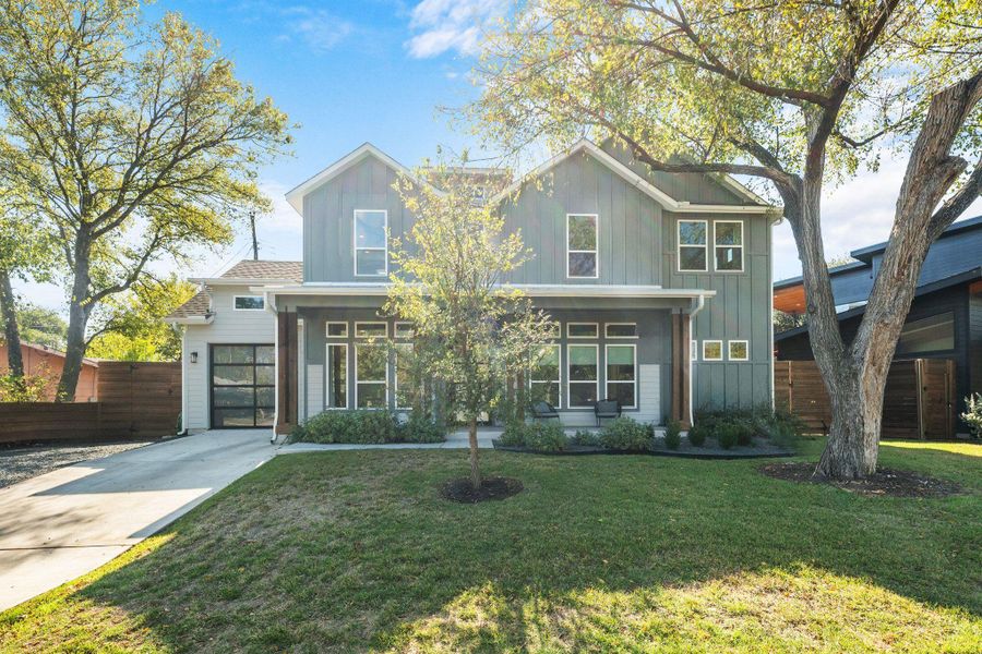 View of front of home with board and batten siding, a porch, and driveway