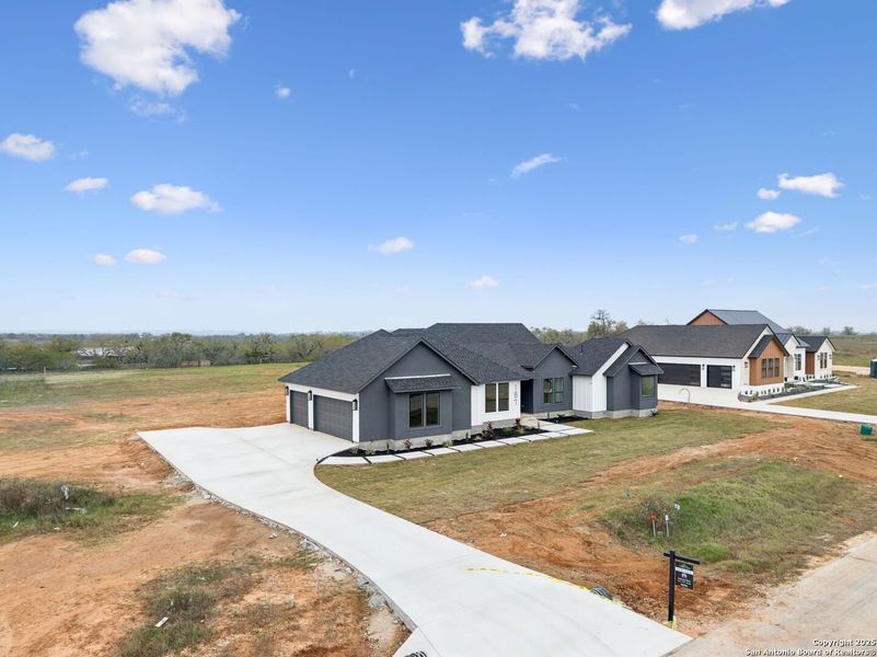 Front exterior of a new home in , Floresville, TX, highlighting curb appeal (Image 2). Front exterior of a new home in , Floresville, TX, highlighting curb appeal (Image 2).