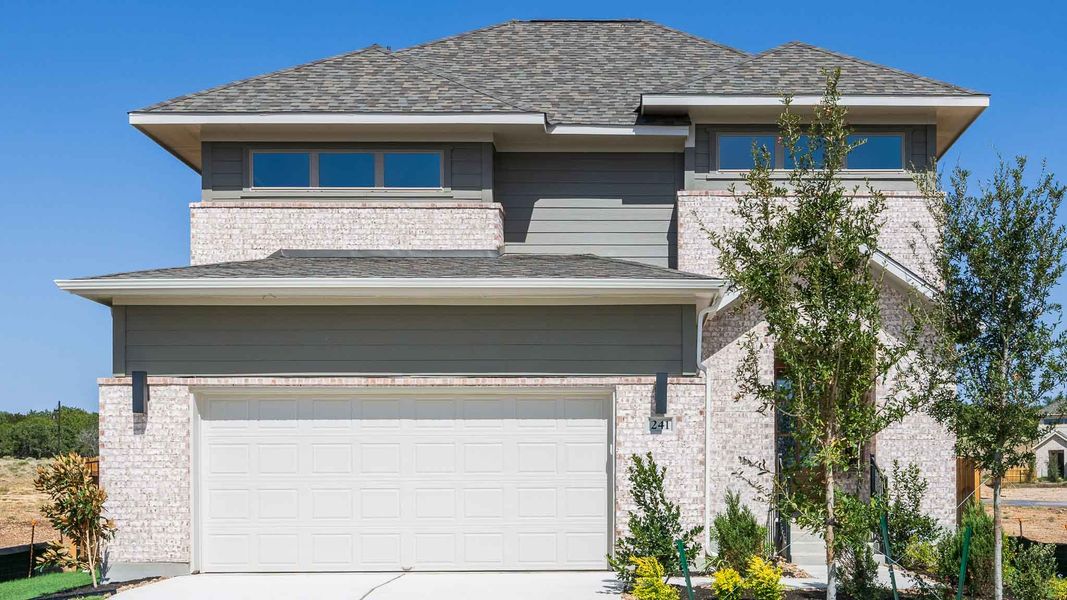 Front exterior of a new home in Santa Rita Ranch - Tierra Rosa, Liberty Hill, TX, highlighting curb appeal (Image 1). Front exterior of a new home in Santa Rita Ranch - Tierra Rosa, Liberty Hill, TX, highlighting curb appeal (Image 1).