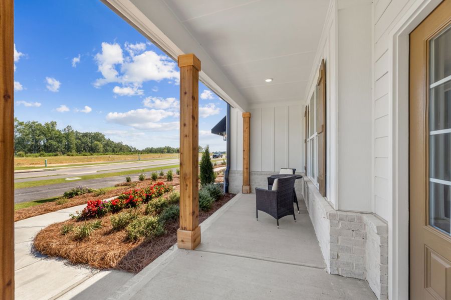 A house with a patio and a table and chairs. A house with a patio and a table and chairs.