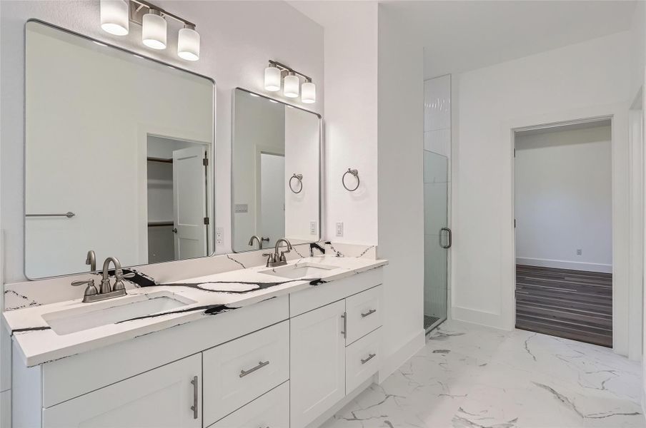 Full bathroom with a stall shower, double vanity