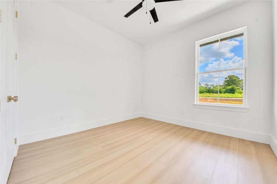 Spacious secondary bedrooms feature large windows that provide abundant natural light and closets with custom built-ins. Spacious secondary bedrooms feature large windows that provide abundant natural light and closets with custom built-ins.