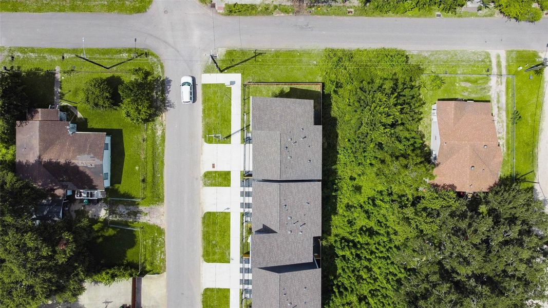 A direct top-down view of the property illustrates the smart site plan, ample driveway parking, and tree-lined backdrop that brings both charm and seclusion. A direct top-down view of the property illustrates the smart site plan, ample driveway parking, and tree-lined backdrop that brings both charm and seclusion.
