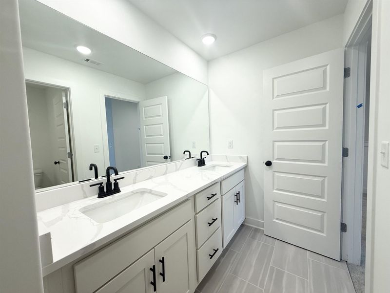 Full bath with double vanity and recessed lighting