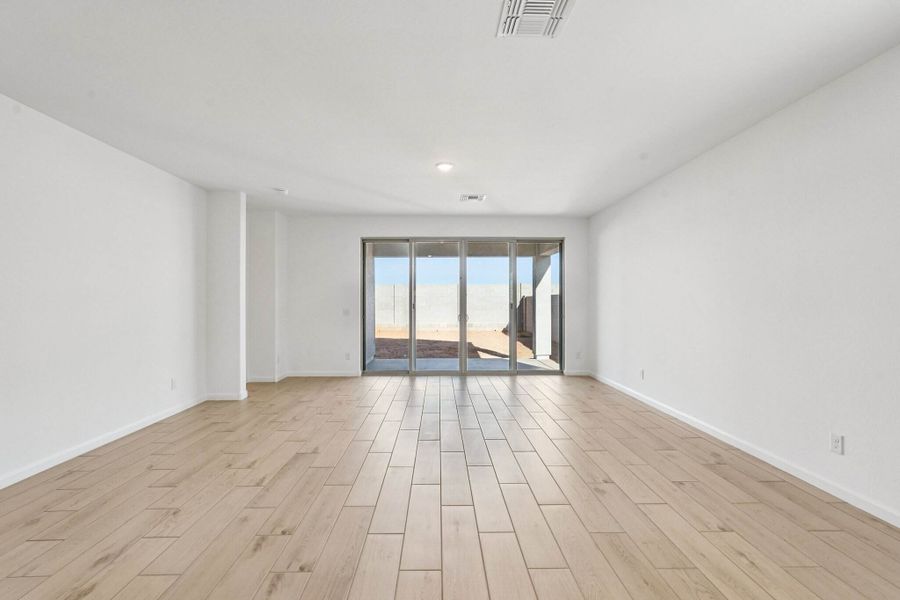 Great room with 4 panel slider to covered patio. Finishes and colors may vary by community.