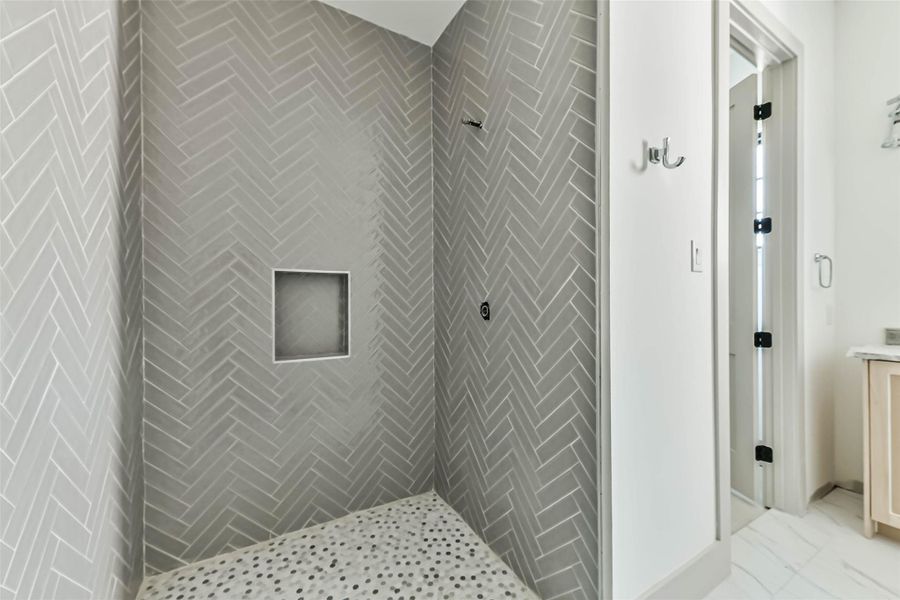 Chevron tile being installed in the glass enclosed walk-in shower off the secondary bedroom. This photo was taken May 26th.