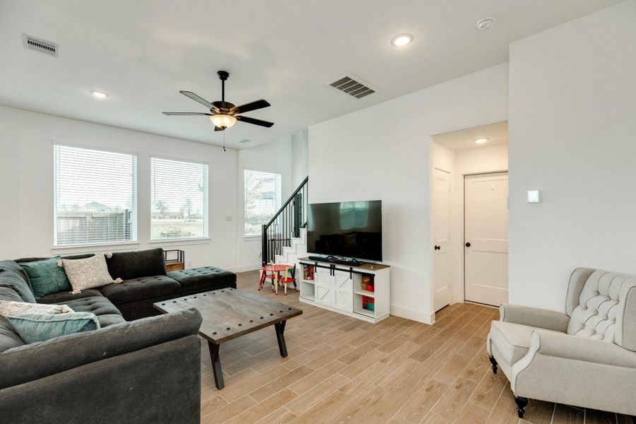 View from Kitchen: The image captures the view from the kitchen area. On the right side, there is a closet followed by the garage entrance. Across from the closet is a half bath.