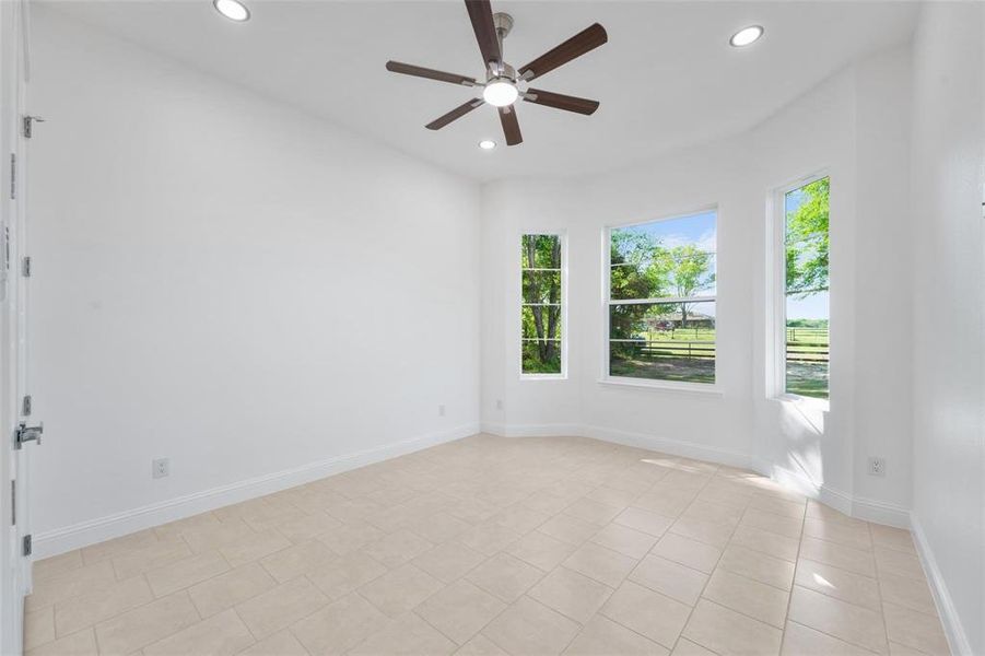 Spare room featuring recessed lighting, ceiling fan, and light tile patterned floors Spare room featuring recessed lighting, ceiling fan, and light tile patterned floors